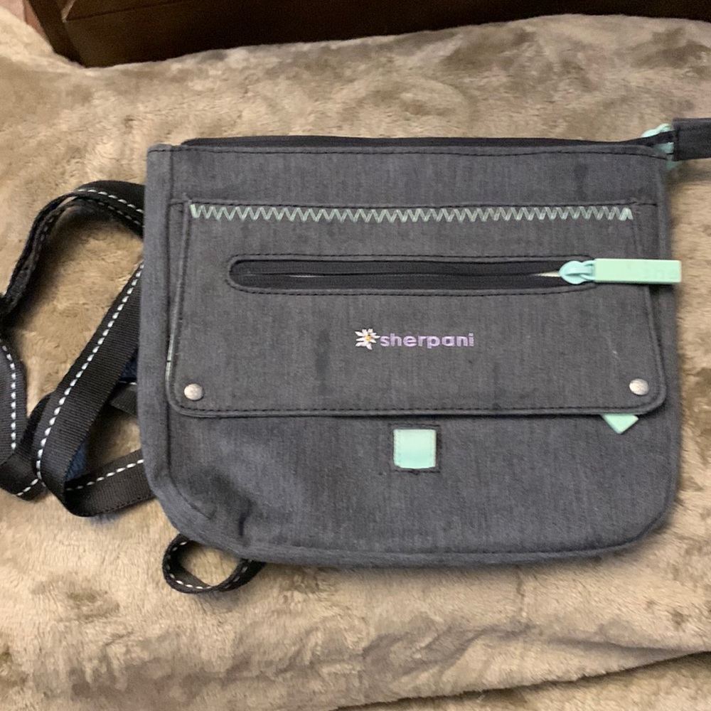 Used Sherpani crossbody bag with adjustable strap.